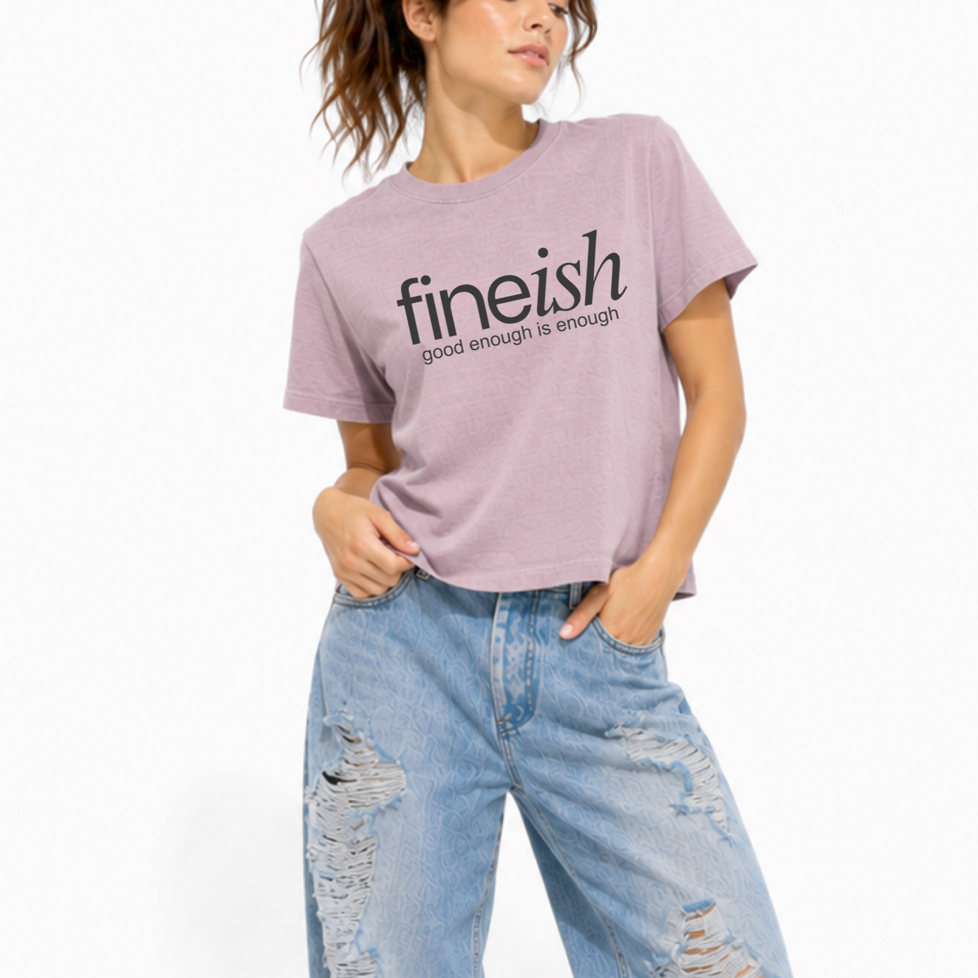 Close-up of the FINEish logo and "Good Enough Is Enough" graphic on a vintage lilac women's t-shirt.