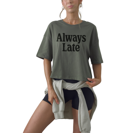 Always Late women’s crop t-shirt featuring bold funny statement design. Trendy fitted cropped graphic tee.