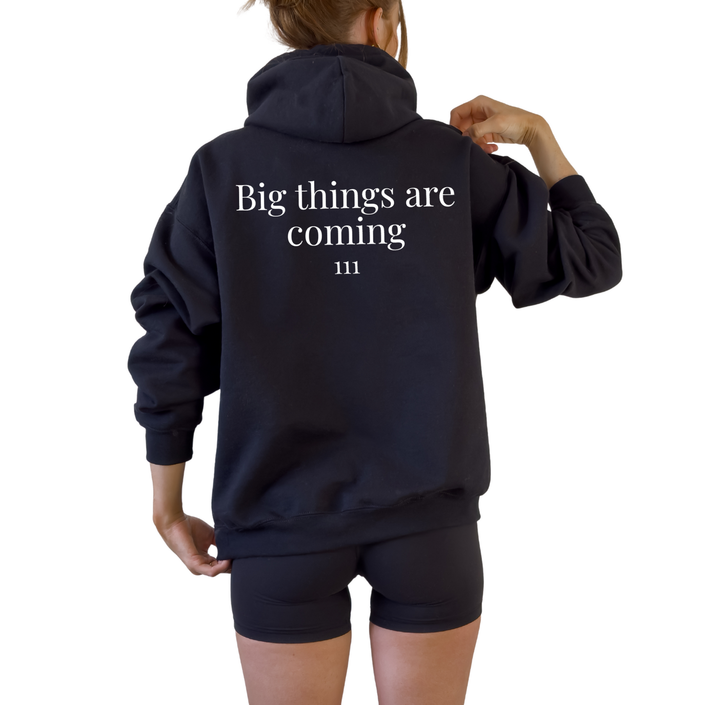 Unisex angel number 111 black hoodie with minimal front graphic and bold back print reading big things are coming, manifestation sweatshirt for spiritual lifestyle, law of attraction clothing, cozy oversized hooded sweatshirt, neutral aesthetic hoodie for everyday wear, positive energy fashion piece