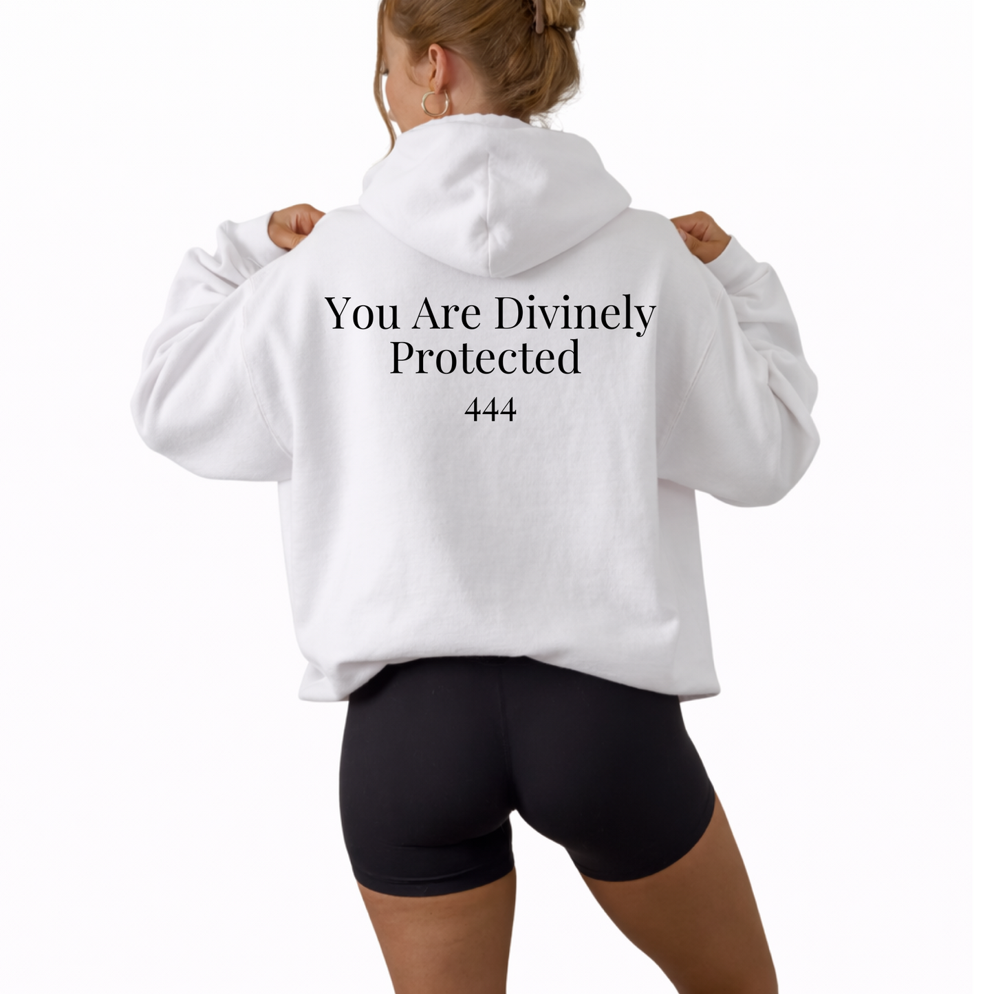 Unisex white hooded sweatshirt featuring angel number 444 on the front and “You Are Divinely Protected” text design, spiritual hoodie symbolizing protection, guidance, manifestation, and positive energy, soft cozy fabric ideal for everyday wear, mindfulness apparel, numerology inspired fashion piece