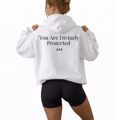 Unisex white hooded sweatshirt featuring angel number 444 on the front and “You Are Divinely Protected” text design, spiritual hoodie symbolizing protection, guidance, manifestation, and positive energy, soft cozy fabric ideal for everyday wear, mindfulness apparel, numerology inspired fashion piece