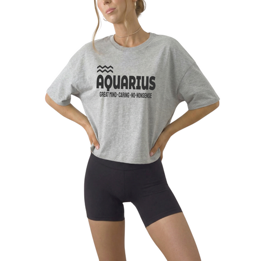 Aquarius astrology women’s cropped t-shirt with bold “Great Mind. Caring. No-Nonsense.” quote and Aquarius sign. Zodiac crop top for intelligent, independent air sign personalities.