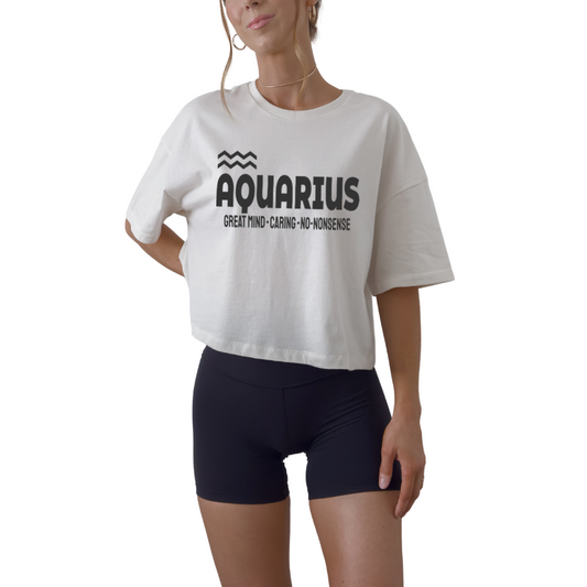 Aquarius zodiac horoscope women’s crop tee featuring “Great Mind. Caring. No-Nonsense.” Astrology graphic crop top for January and February birthdays.