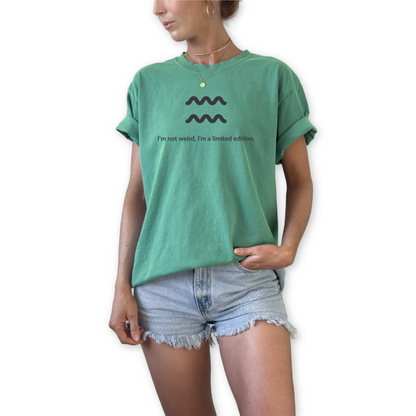 Aquarius zodiac graphic t-shirt featuring the quote "I'm not weird, I'm a limited edition." Astrology inspired unisex tee for Aquarius birthdays, horoscope lovers, and unique personality types.