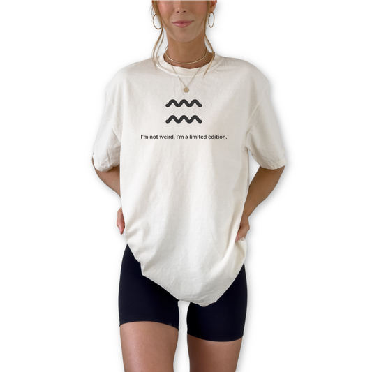 Aquarius zodiac graphic t-shirt featuring the quote "I'm not weird, I'm a limited edition." Astrology inspired unisex tee for Aquarius birthdays, horoscope lovers, and unique personality types.