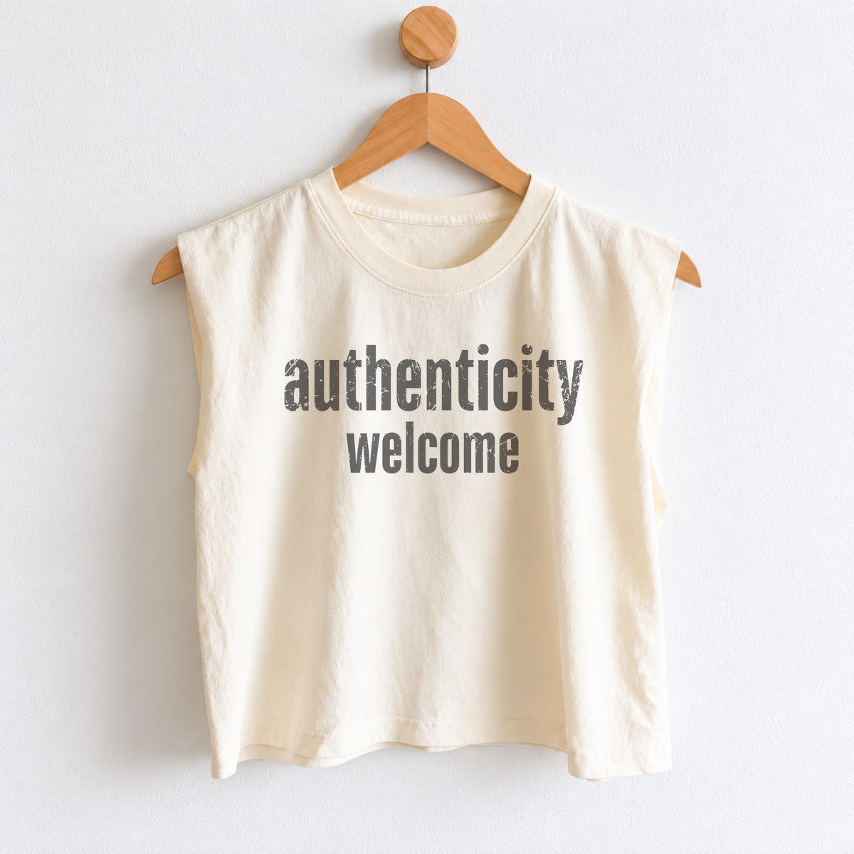 Women’s Authenticity Welcome muscle tank featuring a positive self-love message, heavyweight garment dyed cotton, mid length silhouette, relaxed boxy fit, and sleeveless design.