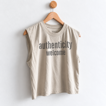 Women’s Authenticity Welcome muscle tank featuring a positive self-love message, heavyweight garment dyed cotton, mid length silhouette, relaxed boxy fit, and sleeveless design.
