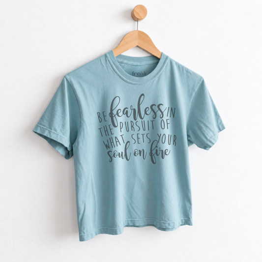 Women’s Be Fearless in the Pursuit of What Sets Your Soul on Fire graphic tee featuring an inspirational motivational message on a relaxed mid length garment dyed T-shirt.