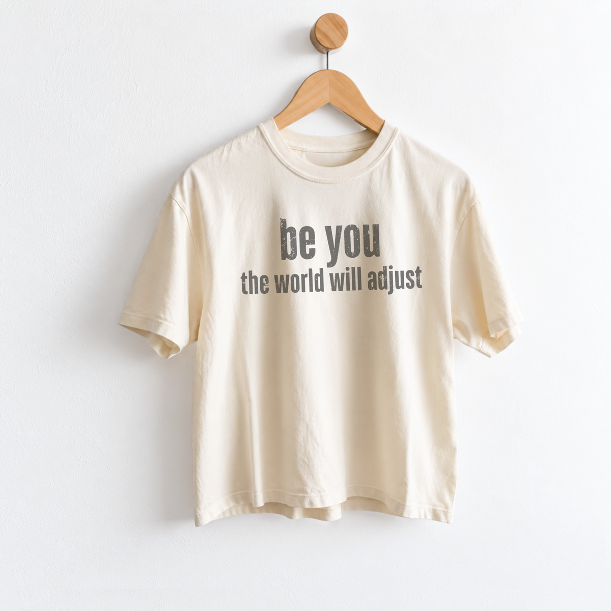Women’s Be You The World Will Adjust graphic tee featuring an empowering self love message, with a relaxed mid length fit perfect for positive everyday style. Shop Fineish