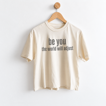 Women’s Be You The World Will Adjust graphic tee featuring an empowering self love message, with a relaxed mid length fit perfect for positive everyday style. Shop Fineish