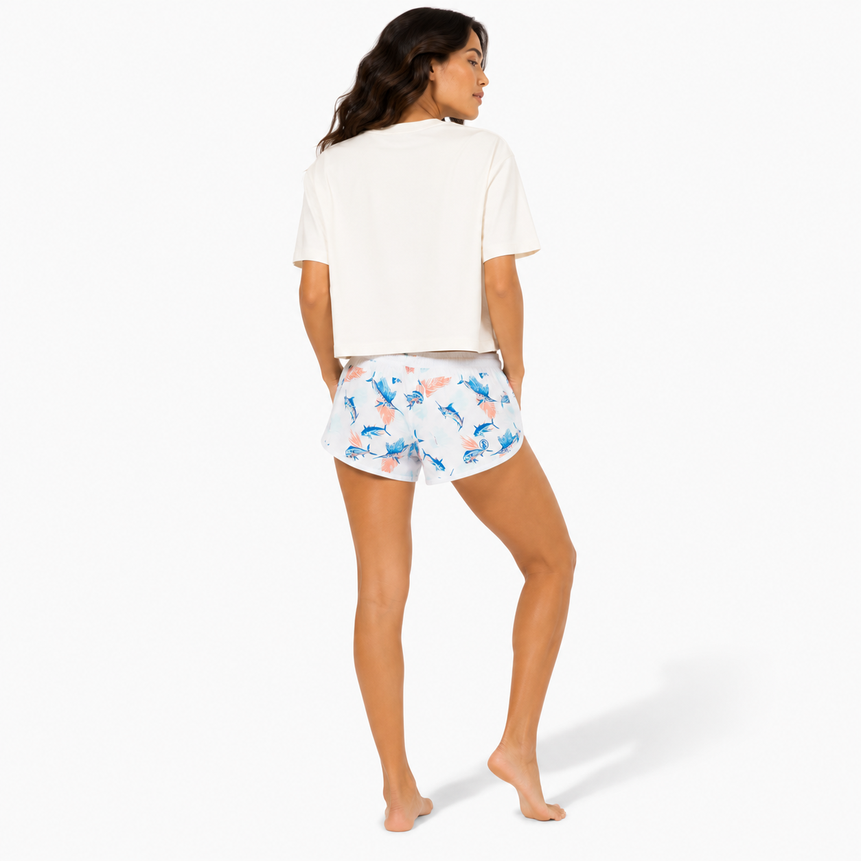 Back view of a women's heavyweight boxy crop tee showing the relaxed cropped fit and clean back while wearing the Beach Soul Barefoot in the Sand graphic shirt.