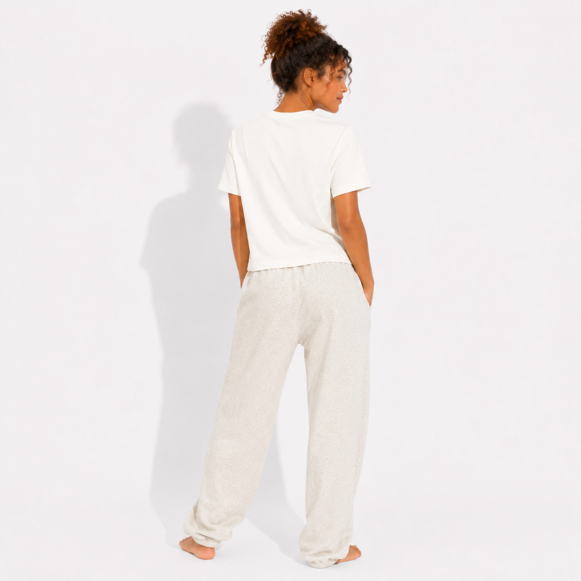 Back view of a women's washed garment-dyed t-shirt showing the relaxed fit and clean back while wearing the Book Gang graphic tee for book lovers.