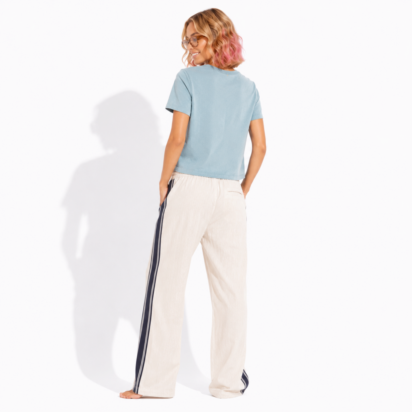 Back view of a women's washed garment-dyed t-shirt showing the relaxed fit and clean back while wearing the Books & Coffee graphic tee.