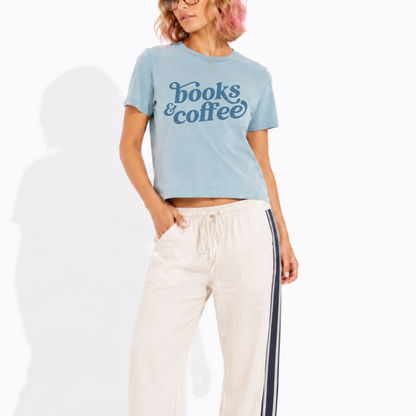 Woman wearing a washed garment-dyed t-shirt with a Books & Coffee graphic, perfect for book lovers, coffee enthusiasts, and cozy reading days.