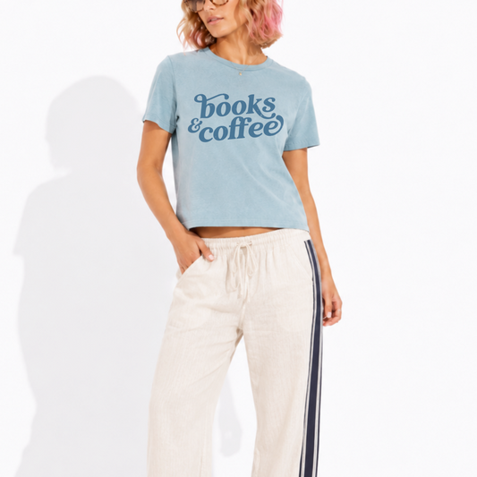 Woman wearing a washed garment-dyed t-shirt with a Books & Coffee graphic, perfect for book lovers, coffee enthusiasts, and cozy reading days.