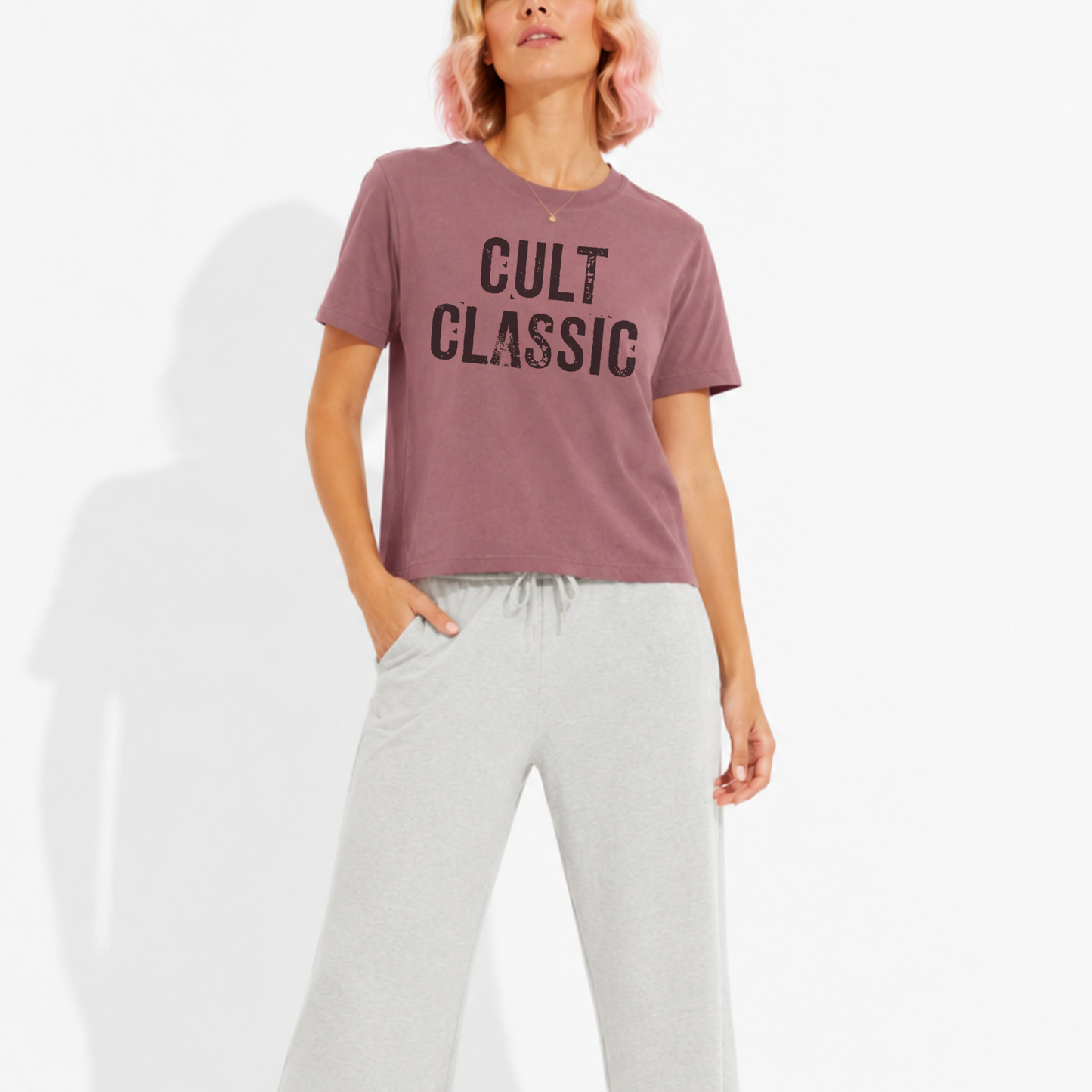 Woman wearing a washed garment-dyed t-shirt with a "Cult Classic" graphic, perfect for book lovers, bibliophiles, and fans of timeless literature.