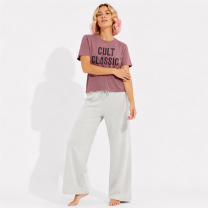 Close-up of the "Cult Classic" graphic printed on a women's washed garment-dyed t-shirt, highlighting the vintage-inspired typography and premium-quality print.