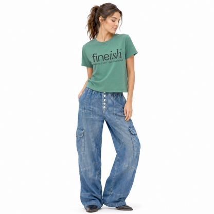 Model wearing a washed pine FINEish women’s graphic T-shirt with the “I Came, I Saw, I Got Distracted” design.