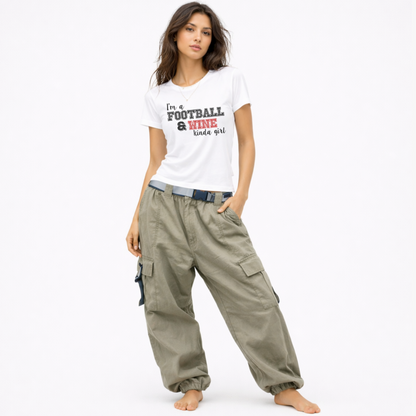 Model wearing a funny football and wine shirt for women styled with a casual game day and tailgate outfit.