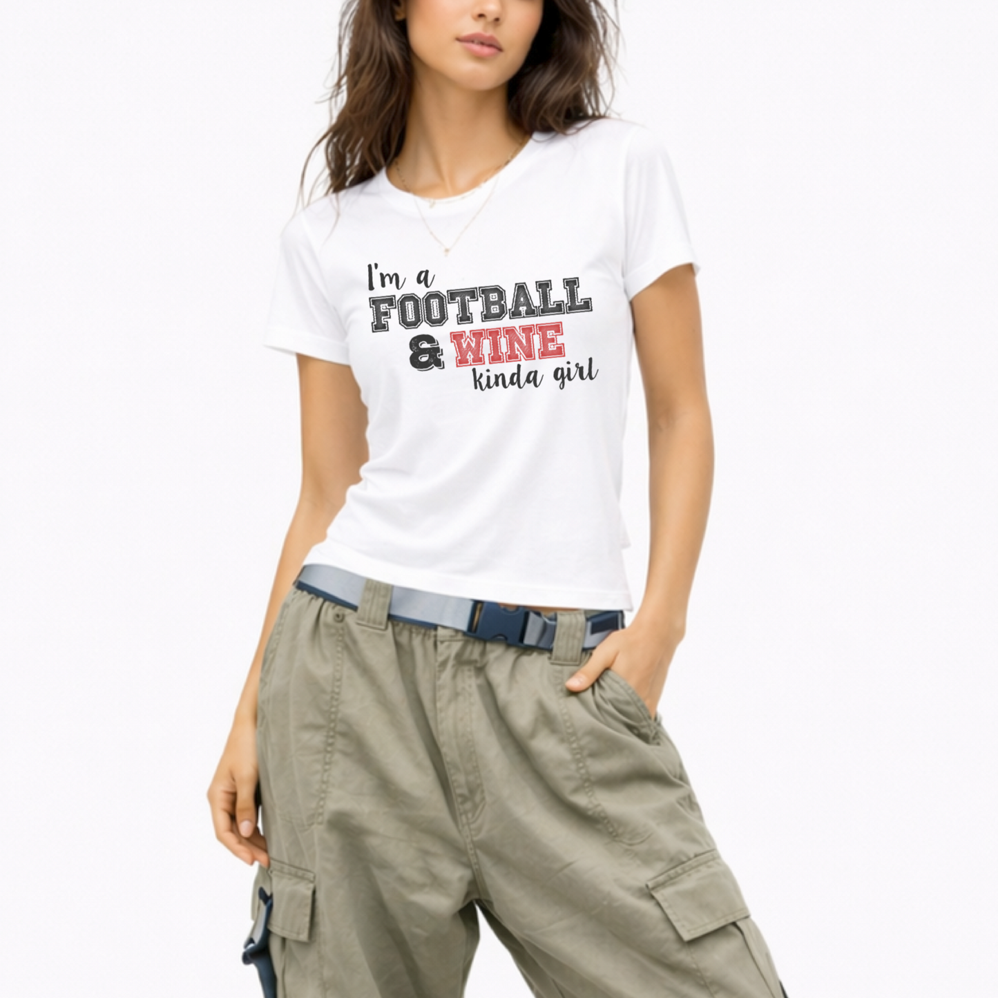 Woman wearing a lightweight graphic T-shirt that says "I'm a Football and Wine Kinda Girl," perfect for football season and game day.