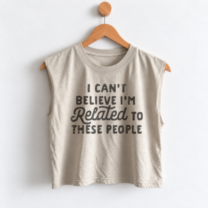 Women’s funny Thanksgiving muscle tank featuring “I Can’t Believe I’m Related to These People” graphic, garment dyed heavyweight fabric, mid length boxy fit, and sleeveless design.
