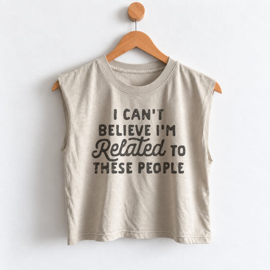Women’s funny Thanksgiving muscle tank featuring “I Can’t Believe I’m Related to These People” graphic, garment dyed heavyweight fabric, mid length boxy fit, and sleeveless design.