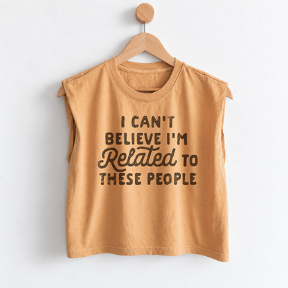 Women’s funny Thanksgiving muscle tank featuring “I Can’t Believe I’m Related to These People” graphic, garment dyed heavyweight fabric, mid length boxy fit, and sleeveless design.