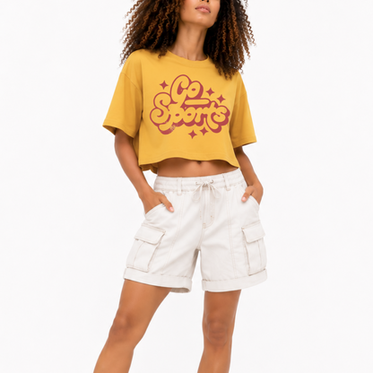 Close-up of the Go Sports retro graphic printed on a women's boxy crop T-shirt.