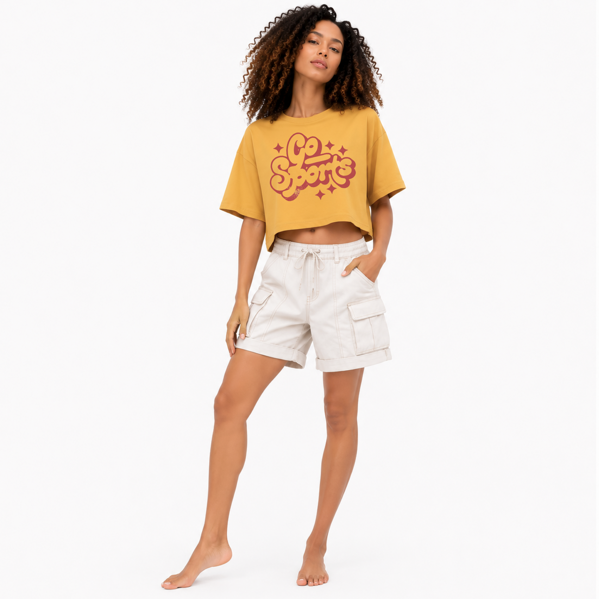 Woman wearing a Go Sports women's boxy crop T-shirt with a funny retro game day graphic.