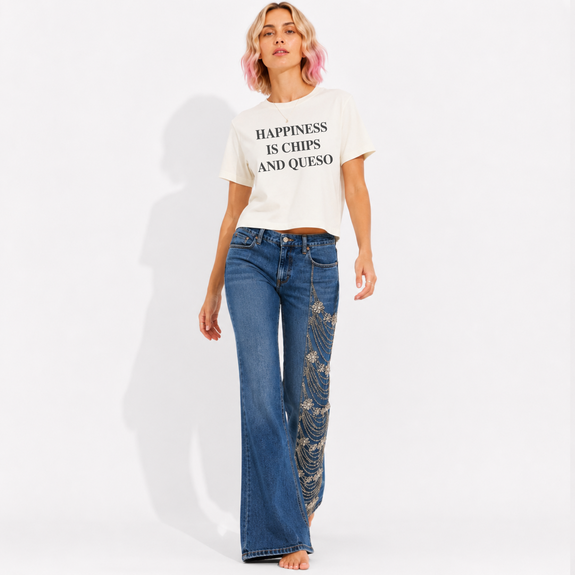 Close-up of the "Happiness Is Chips & Queso" graphic printed on a women's mid-length garment-washed T-shirt.