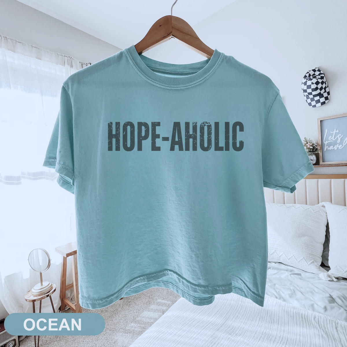 Women’s Hope-aholic graphic tee featuring a playful uplifting message about choosing hope and optimism, with a relaxed mid length fit for easy everyday style. Shop Fineish Tees