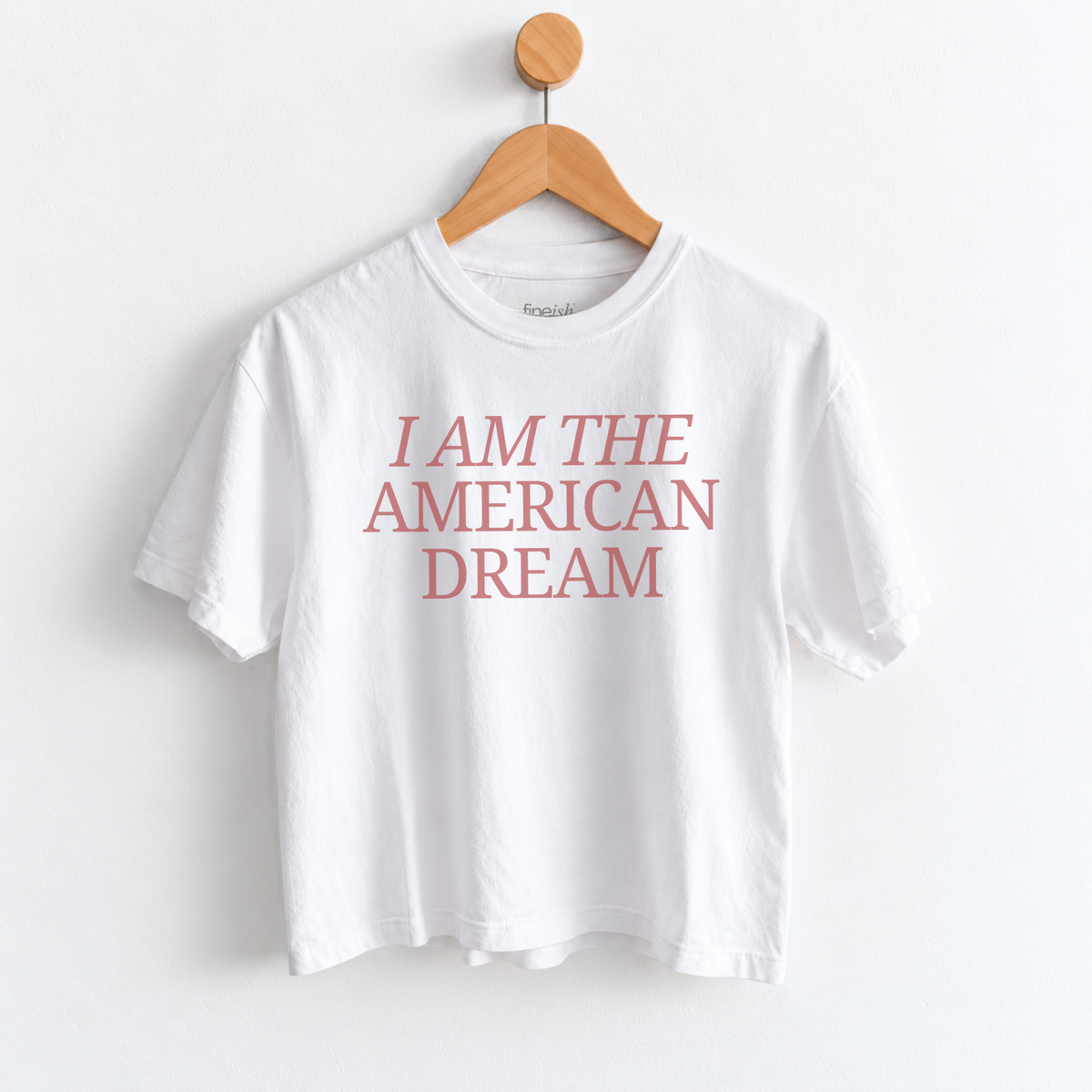 Women’s I Am the American Dream graphic tee featuring a patriotic American saying on a garment dyed mid length T-shirt, perfect for USA style and everyday Americana outfits. Shop Fineish
