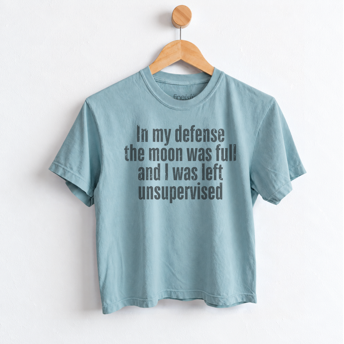 Women’s In My Defense The Moon Was Full and I Was Left Unsupervised graphic tee featuring a funny astrology saying for moon lovers and celestial humor fans. Fineish 