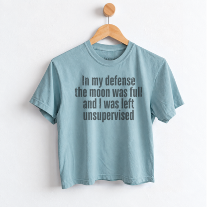 Women’s In My Defense The Moon Was Full and I Was Left Unsupervised graphic tee featuring a funny astrology saying for moon lovers and celestial humor fans. Fineish 