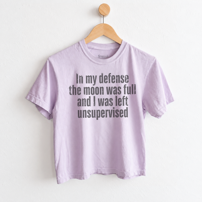 Women’s In My Defense The Moon Was Full and I Was Left Unsupervised graphic tee featuring a funny astrology saying for moon lovers and celestial humor fans. Fineish 