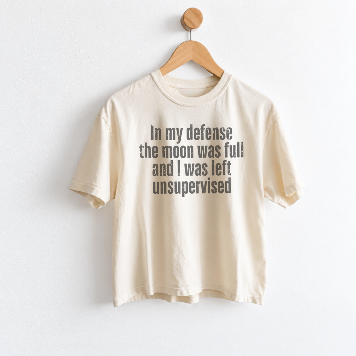 Women’s In My Defense The Moon Was Full and I Was Left Unsupervised graphic tee featuring a funny astrology saying for moon lovers and celestial humor fans. Fineish 