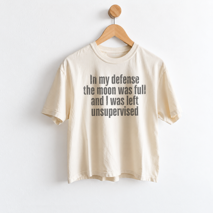 Women’s In My Defense The Moon Was Full and I Was Left Unsupervised graphic tee featuring a funny astrology saying for moon lovers and celestial humor fans. Fineish 