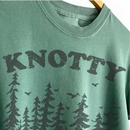 Knotty by Nature boyfriend tee featuring a playful tree and nature inspired graphic, perfect for nature lovers, outdoor adventures, hiking, camping, and woodland style. Shop Fineish