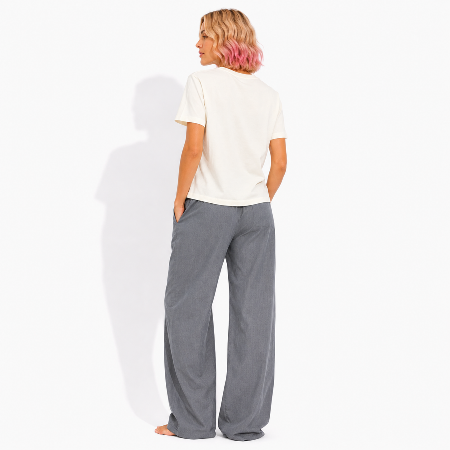 Back view of a women's washed garment-dyed t-shirt showing the relaxed fit and clean back while wearing the "Late Night Reading Society" graphic tee.
