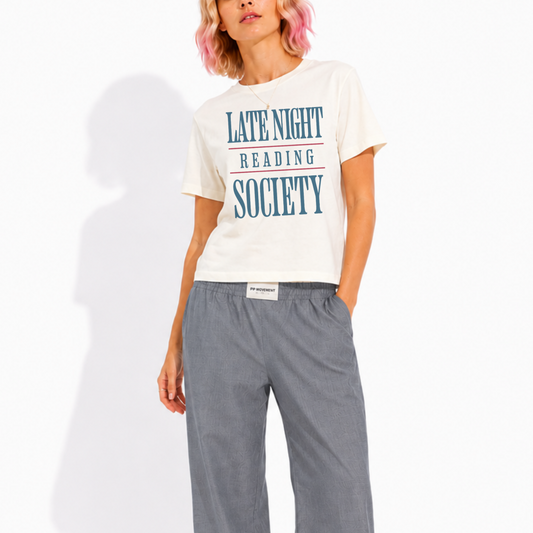 Close-up of the "Late Night Reading Society" graphic printed on a women's washed garment-dyed t-shirt, highlighting the vintage-inspired typography and premium print quality.