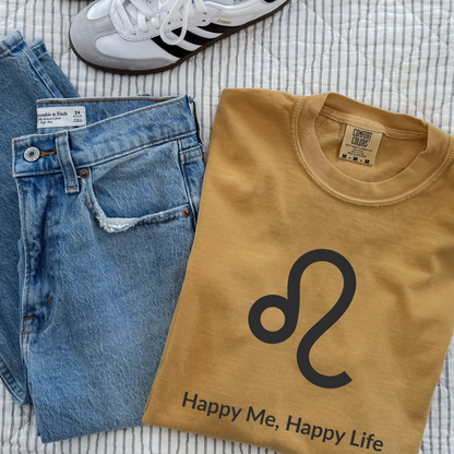 Funny Leo zodiac horoscope shirt featuring “Happy Me Happy Life.” Unique astrology gift for Leo birthdays, fire sign apparel, and horoscope fans who love bold statement tees.