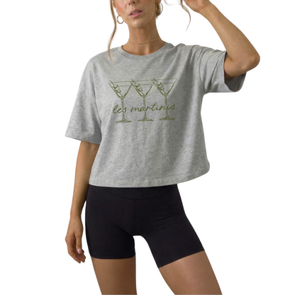 Women’s Les Martinis cropped graphic t-shirt styled for European summer and cocktail bar outfit. French inspired martini slogan crop top in off white mustard and athletic gray. Trendy girls trip outfit shirt perfect for bachelorette weekend and rooftop drinks