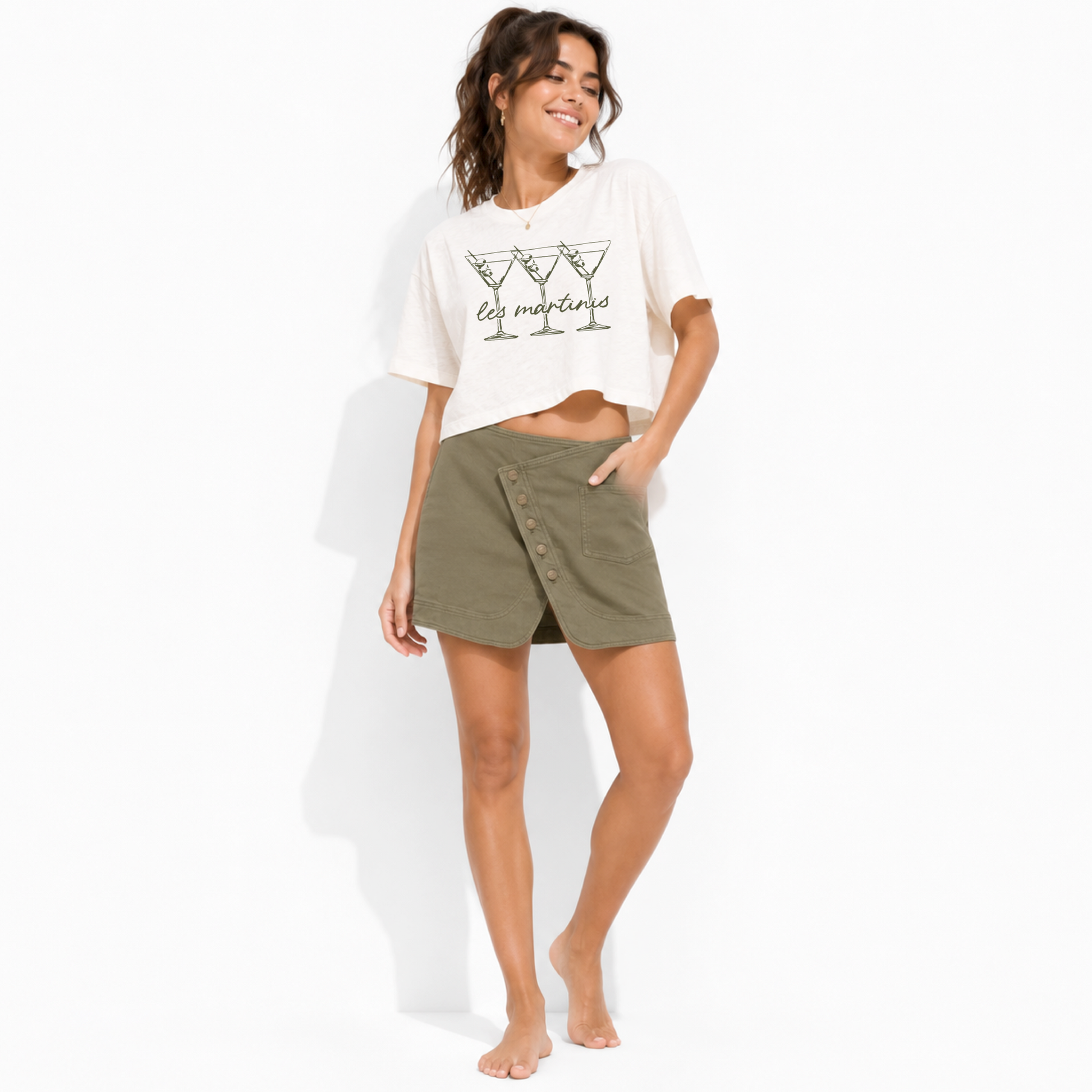 Model wearing a vintage white women’s boxy crop top featuring a playful Les Martinis cocktail design.