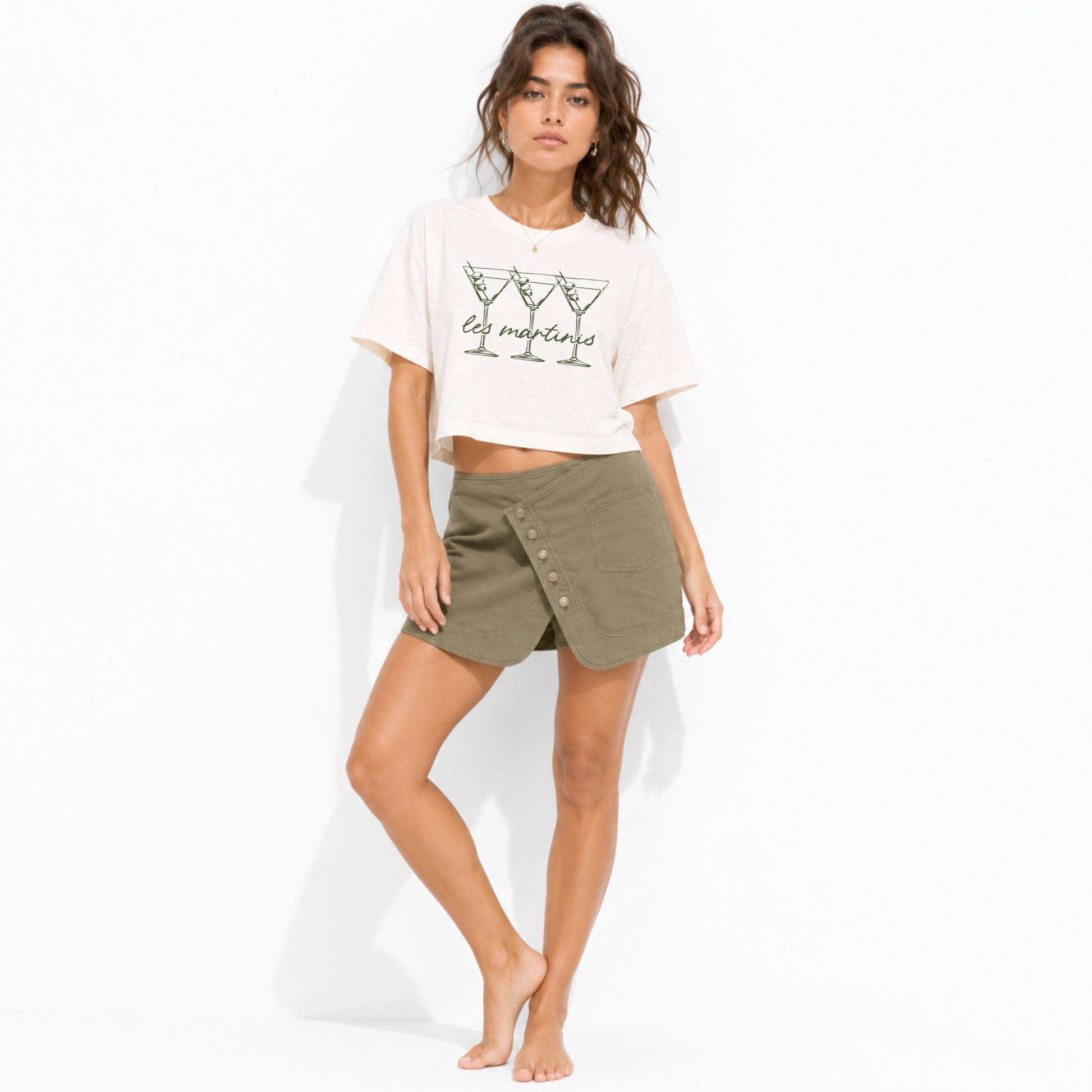 Close-up of the Les Martinis lettering and martini glass graphics printed on a vintage white women’s boxy crop T-shirt.