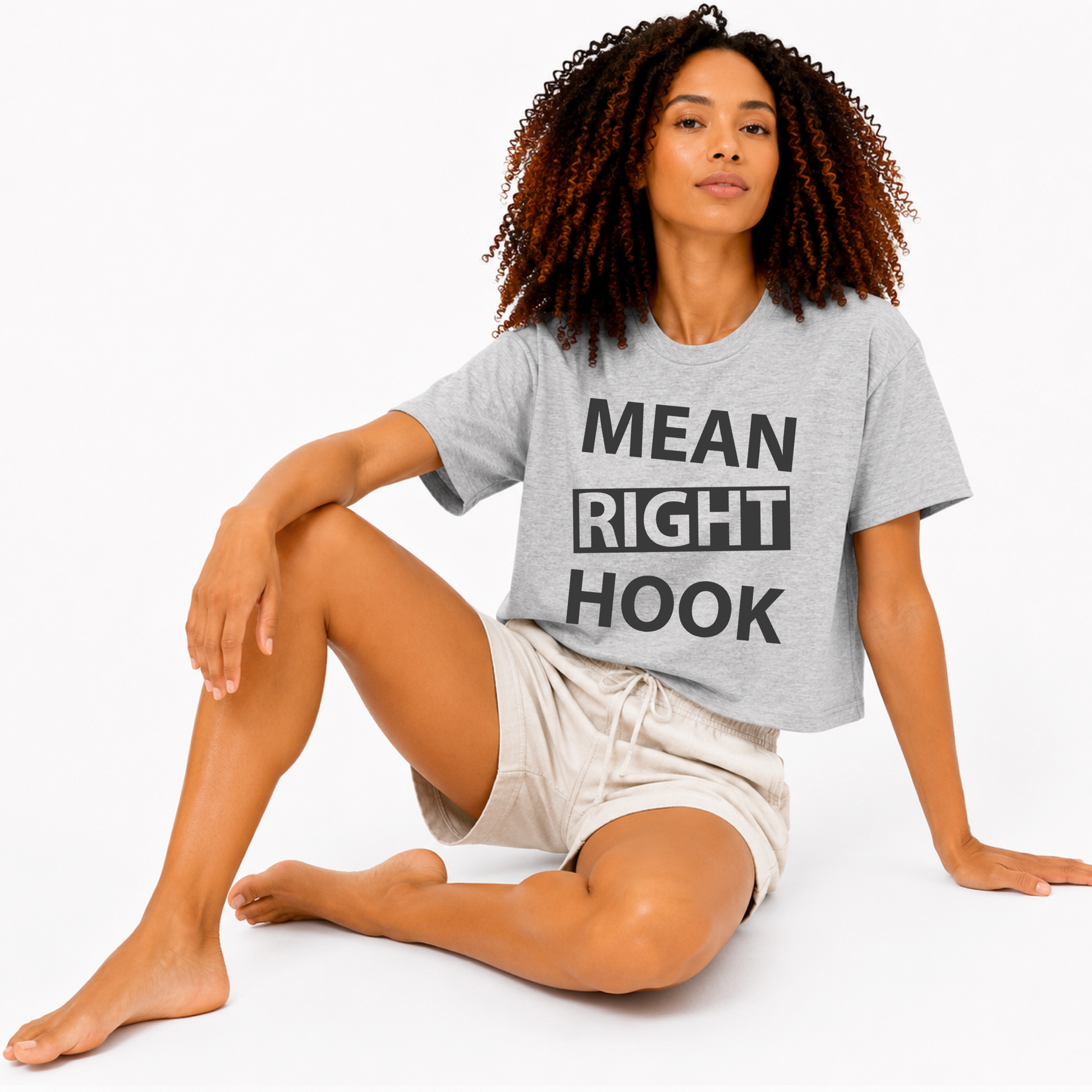Close-up of the “Mean Right Hook” graphic printed on an athletic heather grey women’s boxy crop T-shirt.