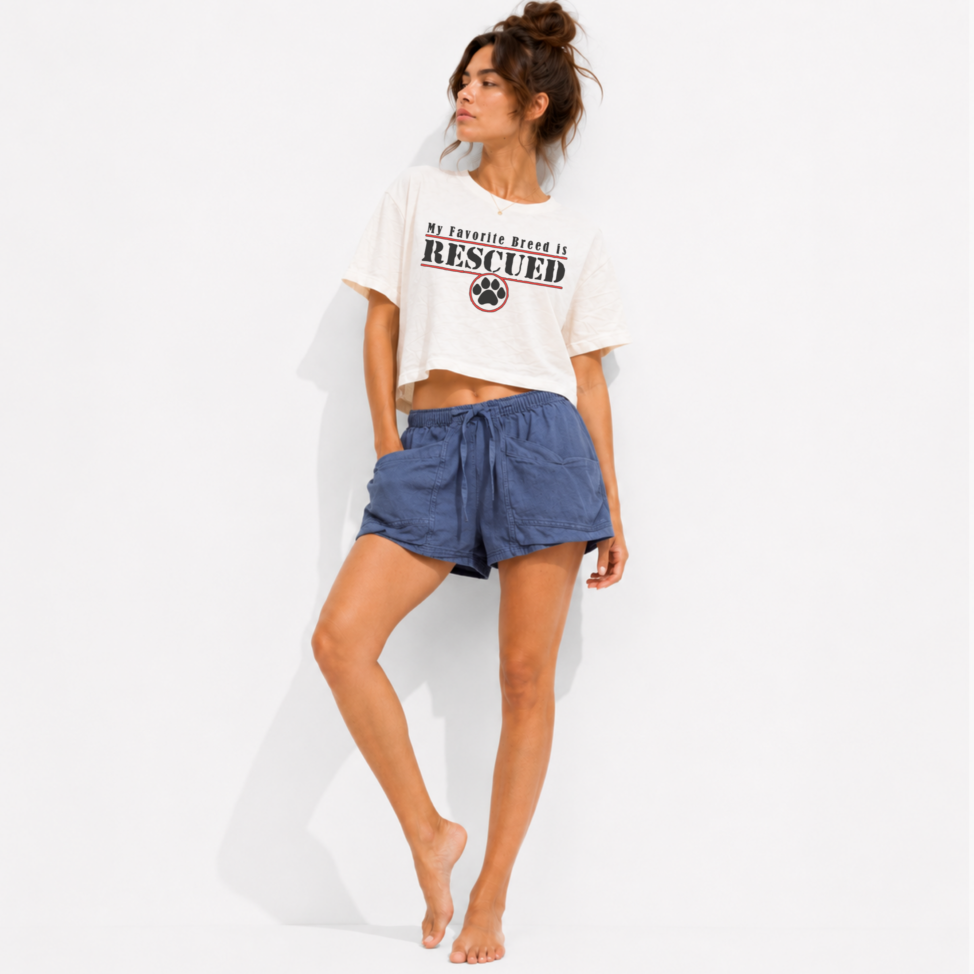 Lifestyle image of the My Favorite Breed Is Rescued women's cropped graphic t-shirt styled for everyday wear, celebrating rescue dogs, animal adoption, and compassionate dog lovers.