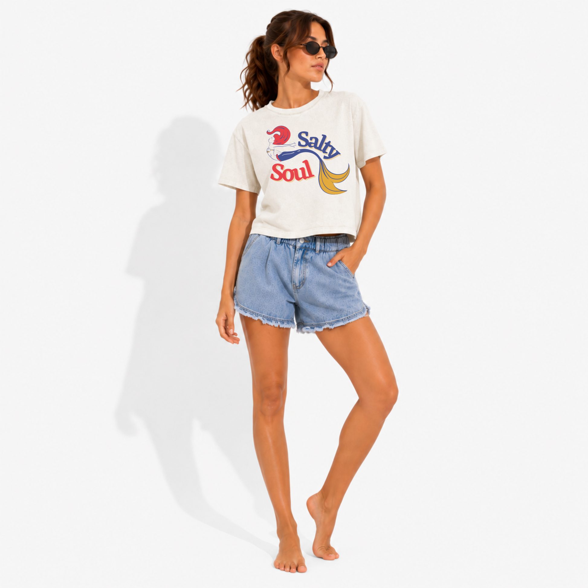 Women's relaxed boxy crop t-shirt with a Salty Soul mermaid design, styled for a beach vacation with effortless coastal fashion and ocean-inspired vibes.