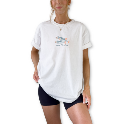 Seas the Day St Tropez France retro unisex t-shirt featuring sardine coastal graphic design. Vintage French Riviera beach shirt with Seas the Day slogan and seaside artwork.
