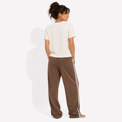 Back view of a women's washed garment-dyed t-shirt showing the relaxed fit and clean back while wearing the Spicy Books & Icy Coffee graphic tee for readers and coffee lovers.