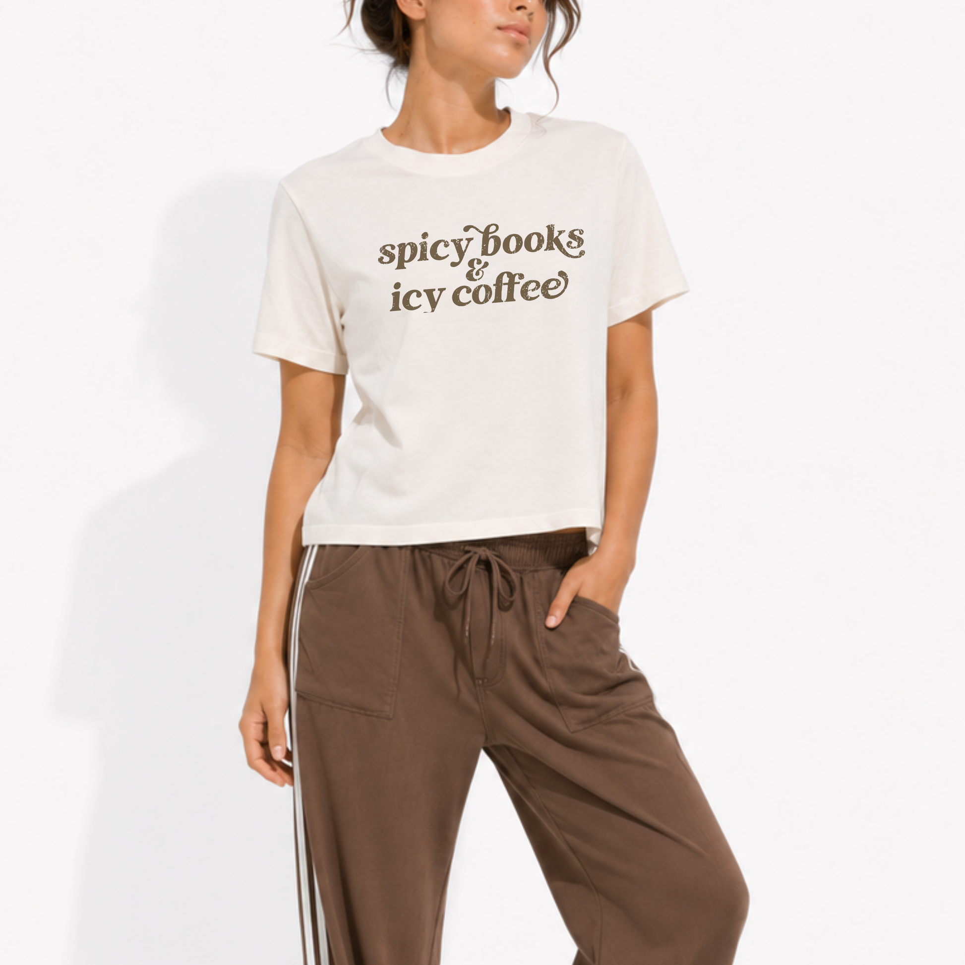 Women's vintage-style garment-dyed Spicy Books & Icy Coffee t-shirt styled for a cozy bookstore or coffee shop with a relaxed casual outfit.